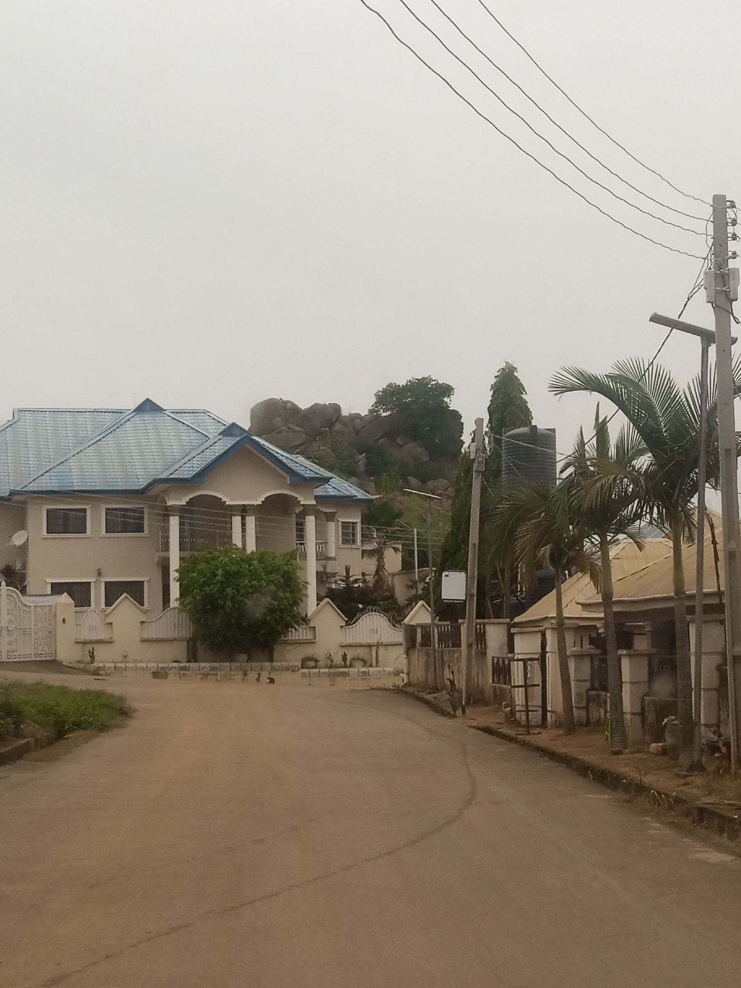 Dirt roads, heavy vehicles, and everyday movement in a busy area