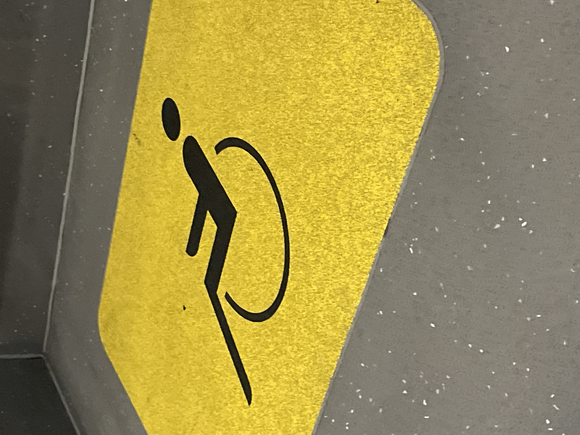 Accessibility sign documented on grey surface in Barcelona