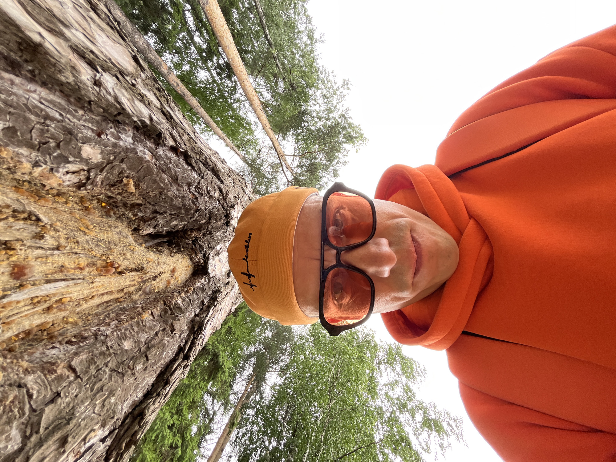 Person takes outdoor selfie in orange hoodie in Chaikovsky