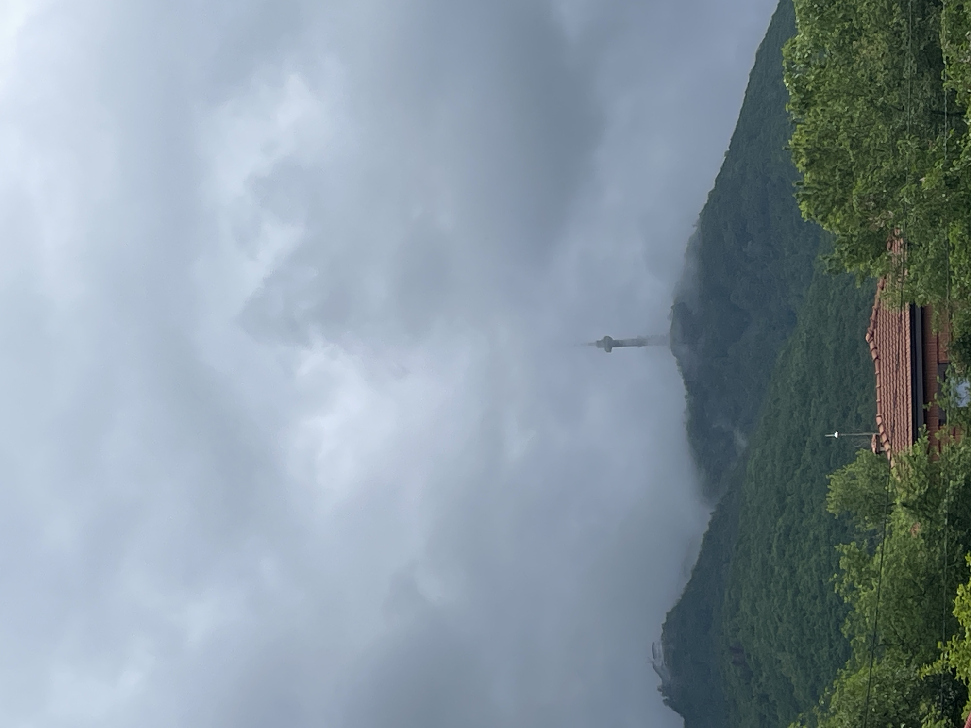 Mountain communications tower emerges from heavy fog