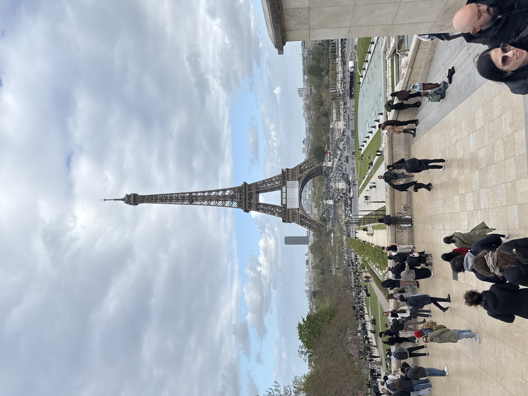 Eiffel Tower photographed against cloudy Parisian sky