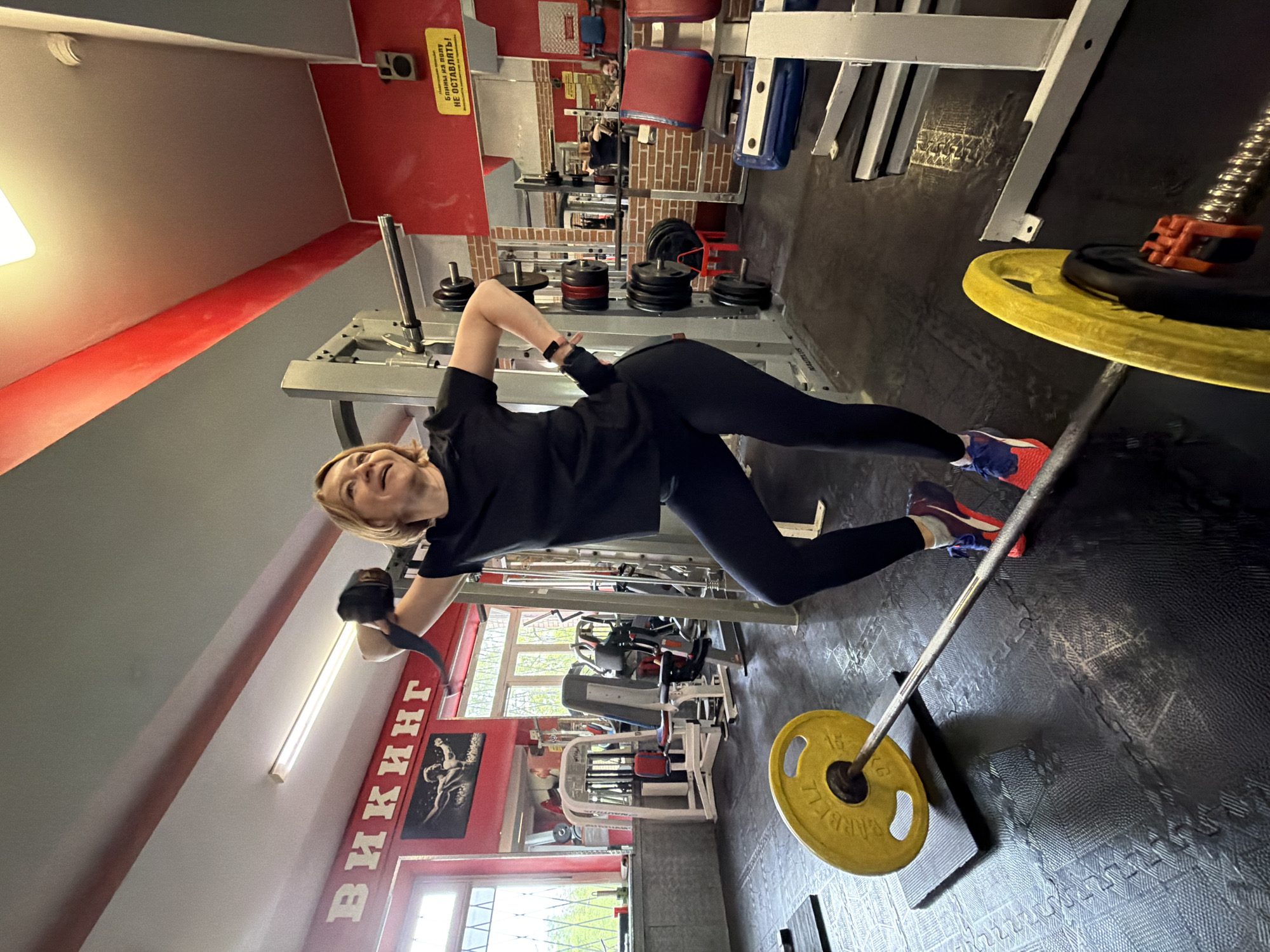 Woman completes strength training workout at Saint Petersburg gym