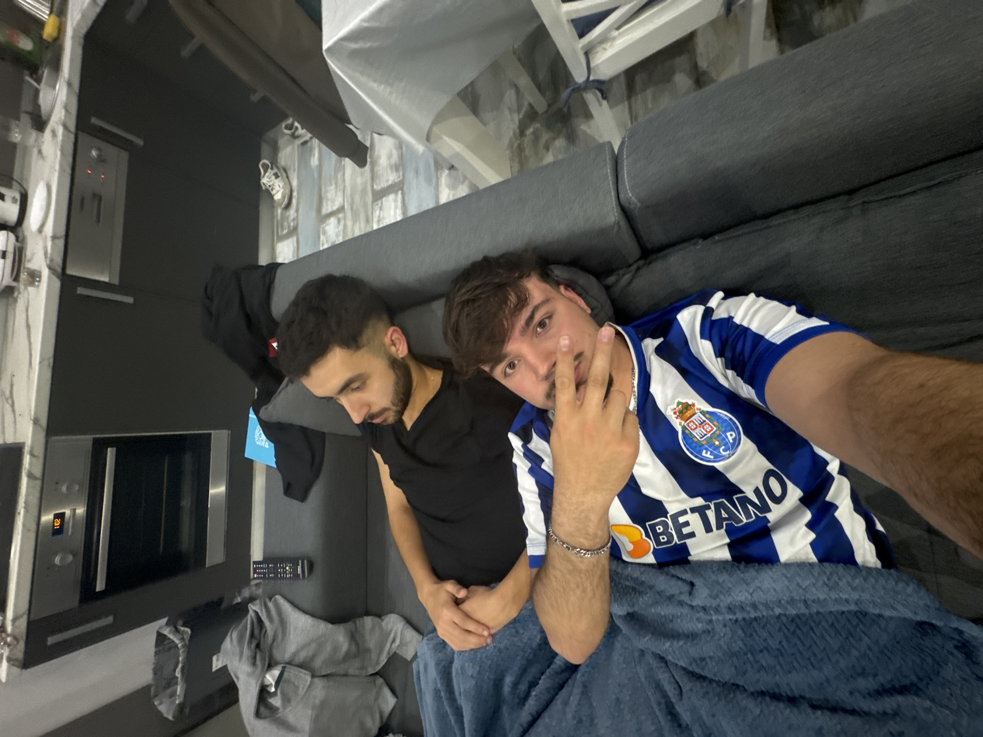 Two men rest on sofa in Rijeka apartment