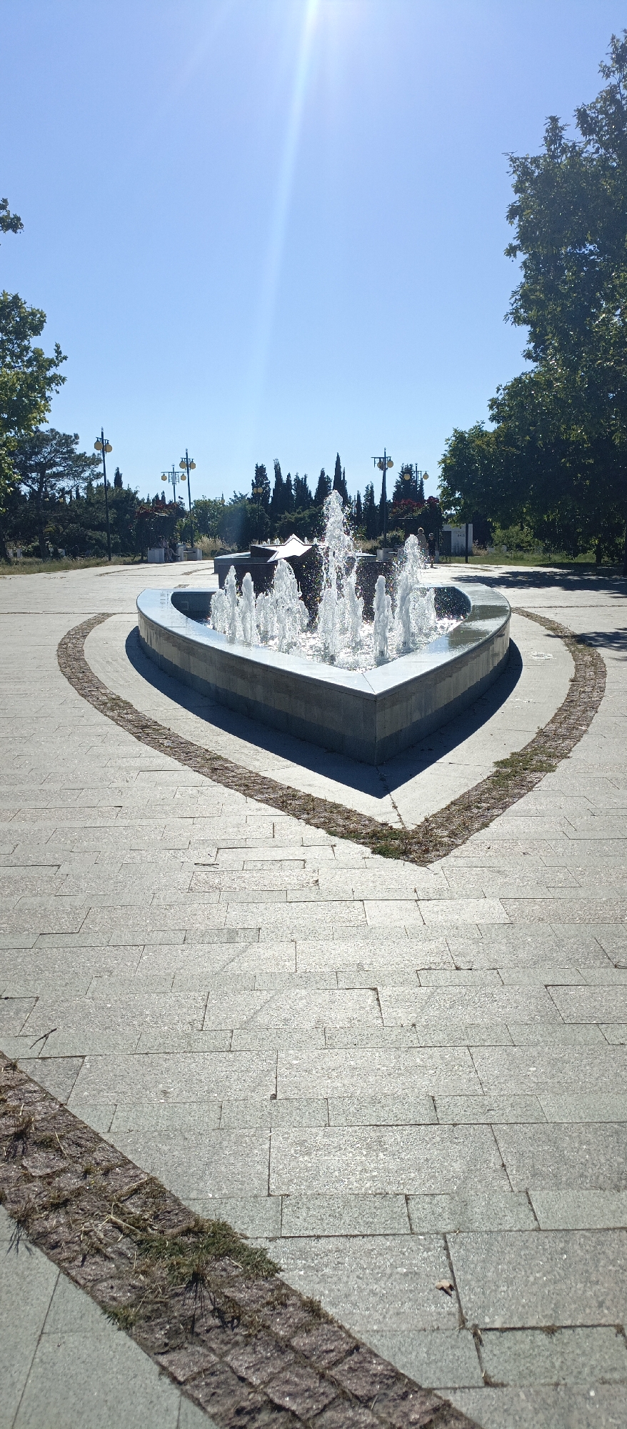 Heart-shaped fountain and Stalingrad memorial in sunny park setting