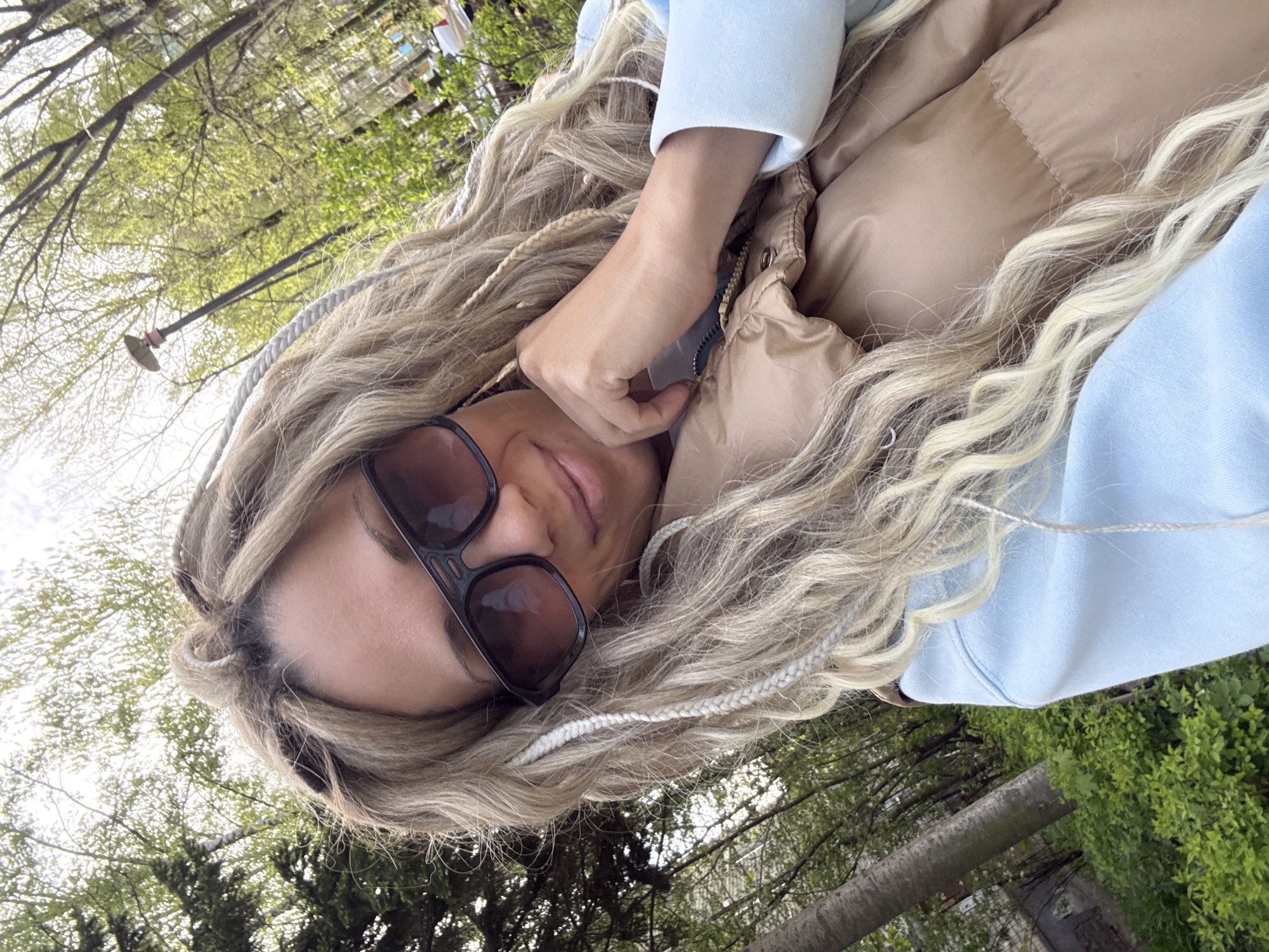 Woman takes morning selfie outdoors in casual attire