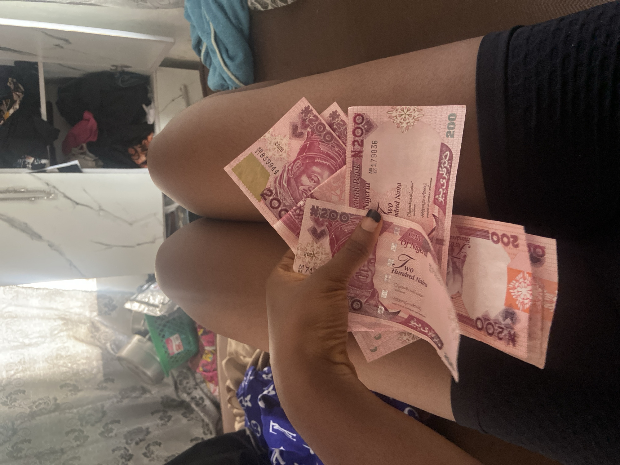 Person counts Nigerian banknotes in Lokoja