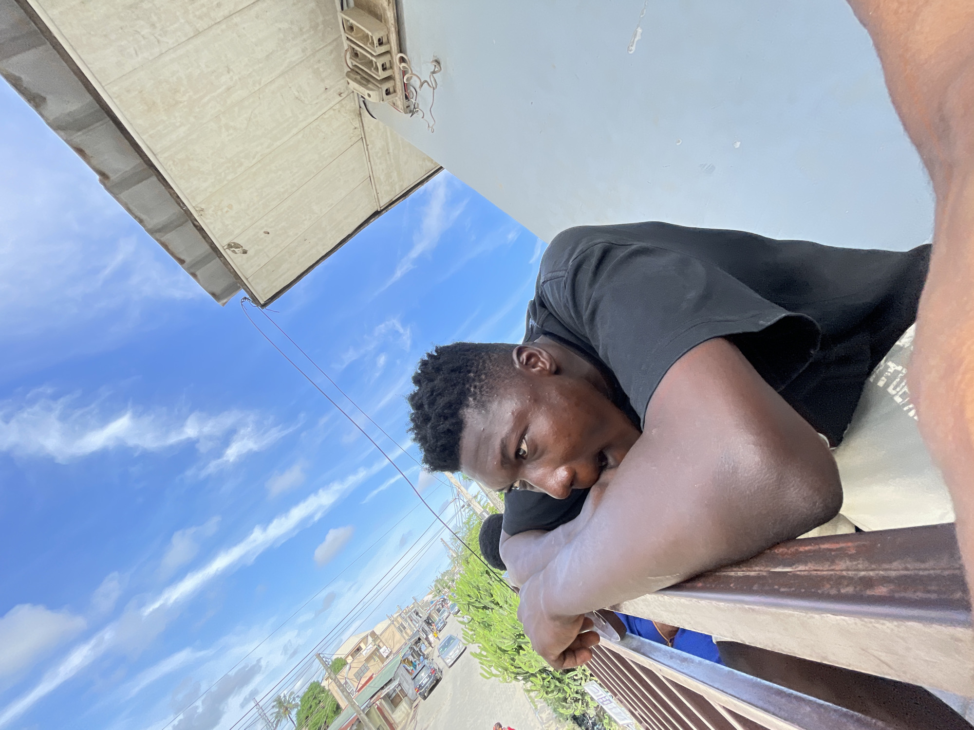 Young man documents street life from Ado balcony