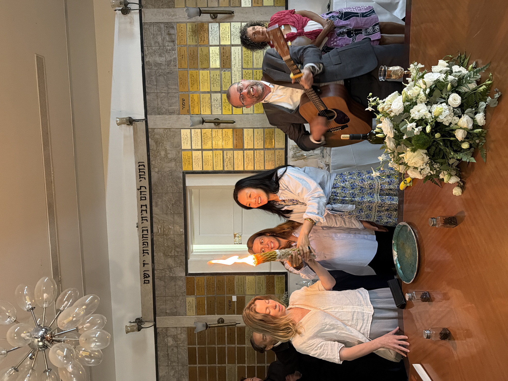 Indoor candle ceremony with women and man in Tel-Aviv