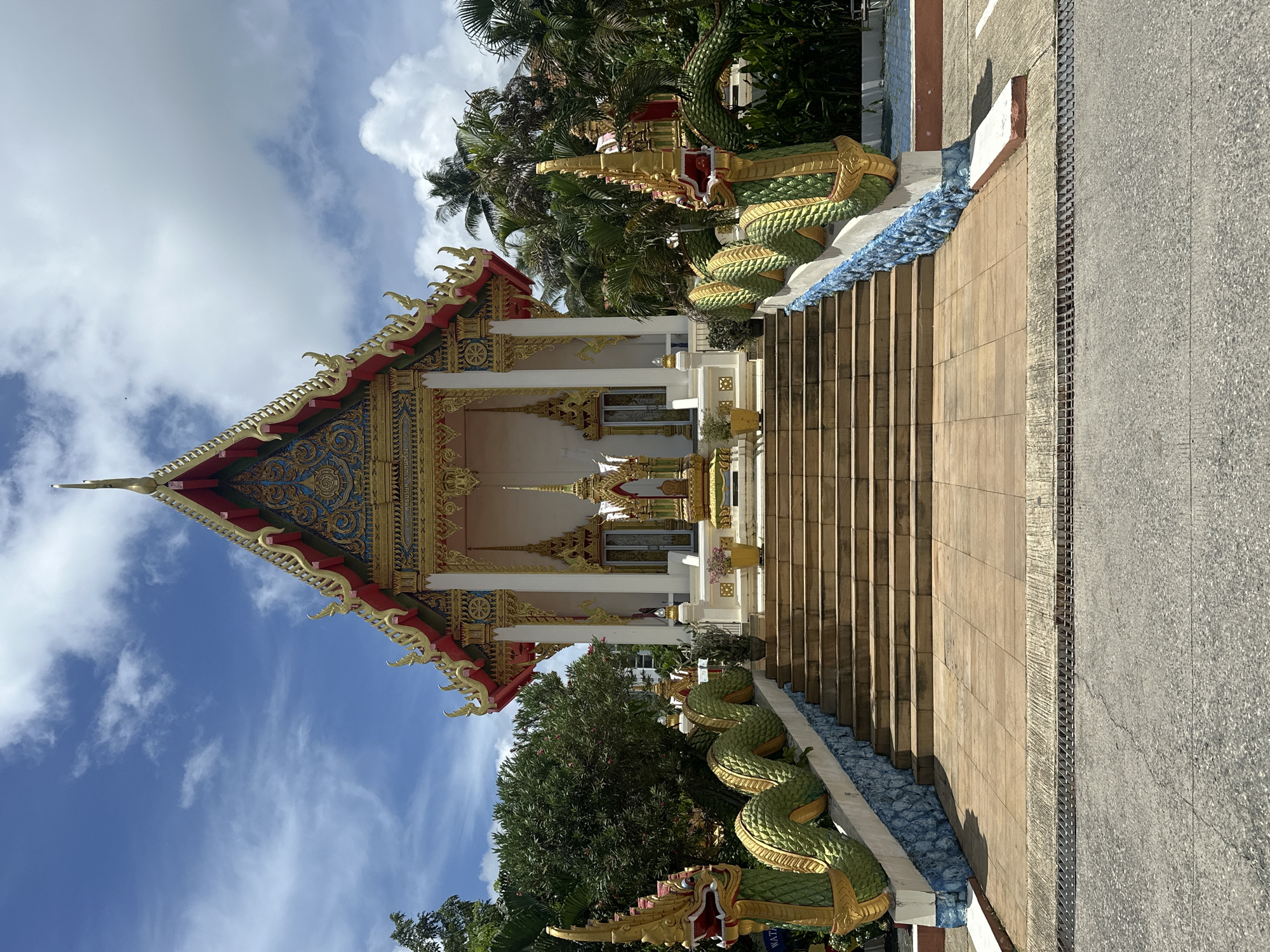 Karon temple morning: ornate shrines and a sleeping cat