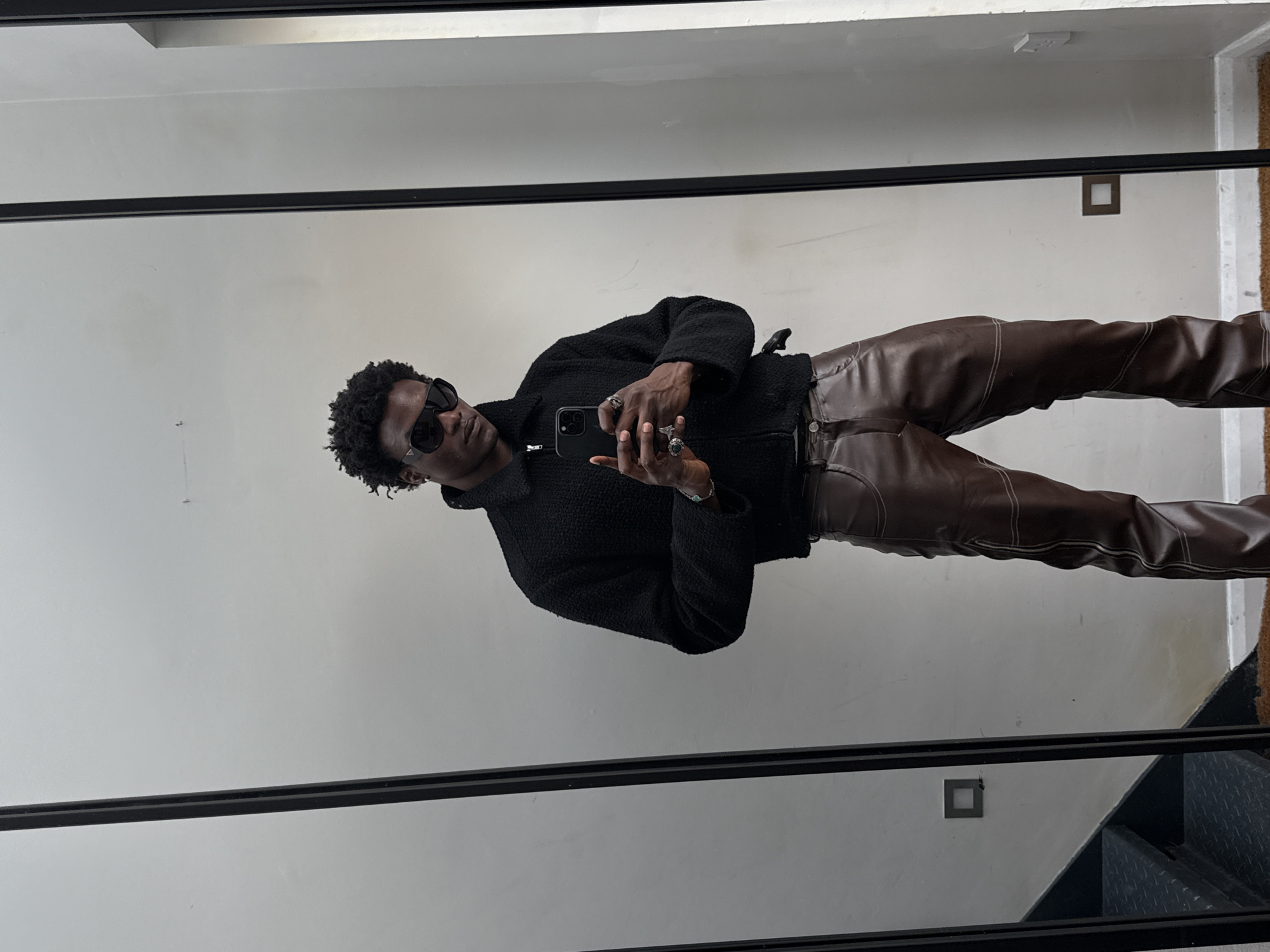Person in sunglasses observed at mirror in London