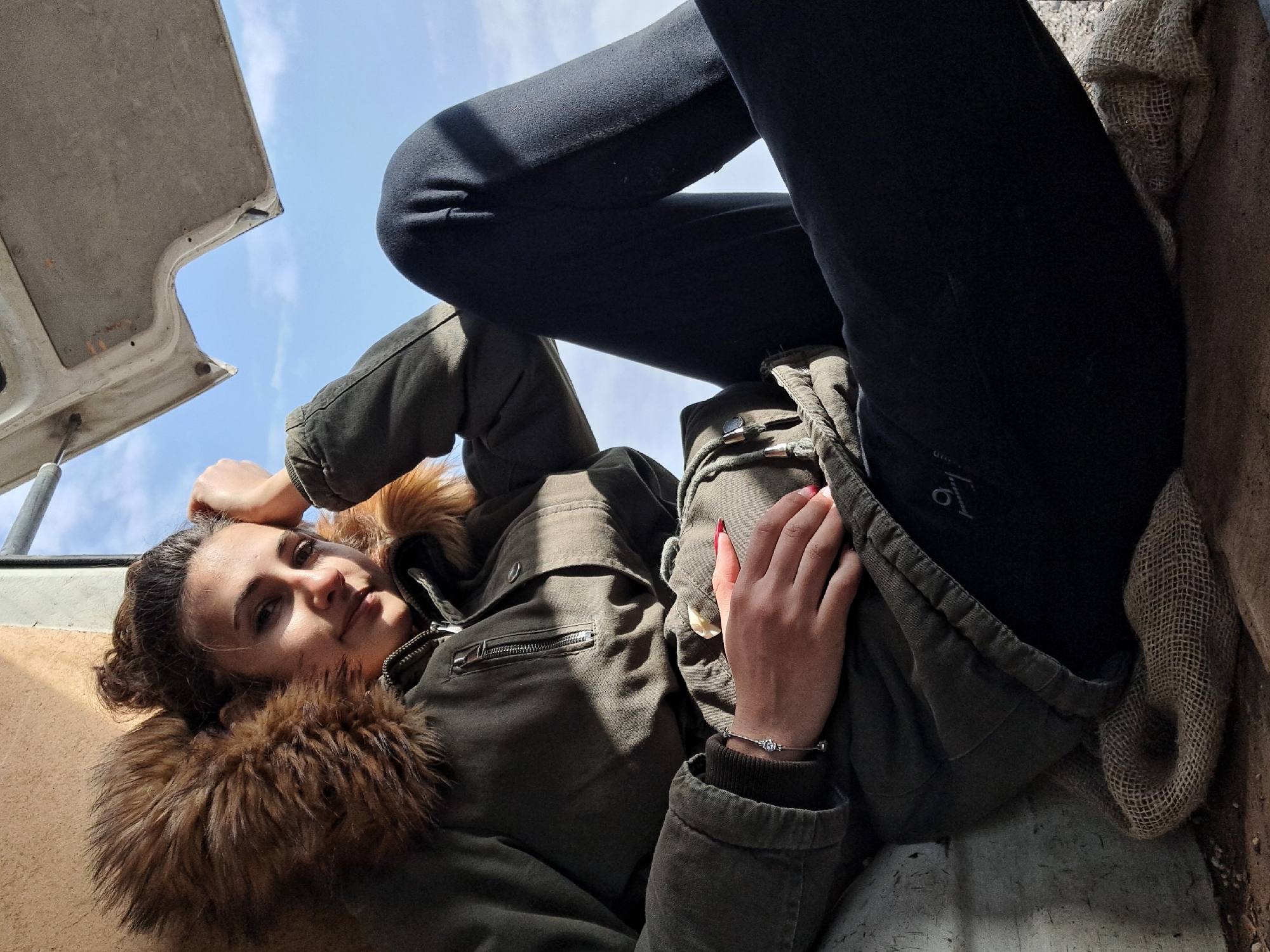Woman rests during spring farming activity in Bulgarian village