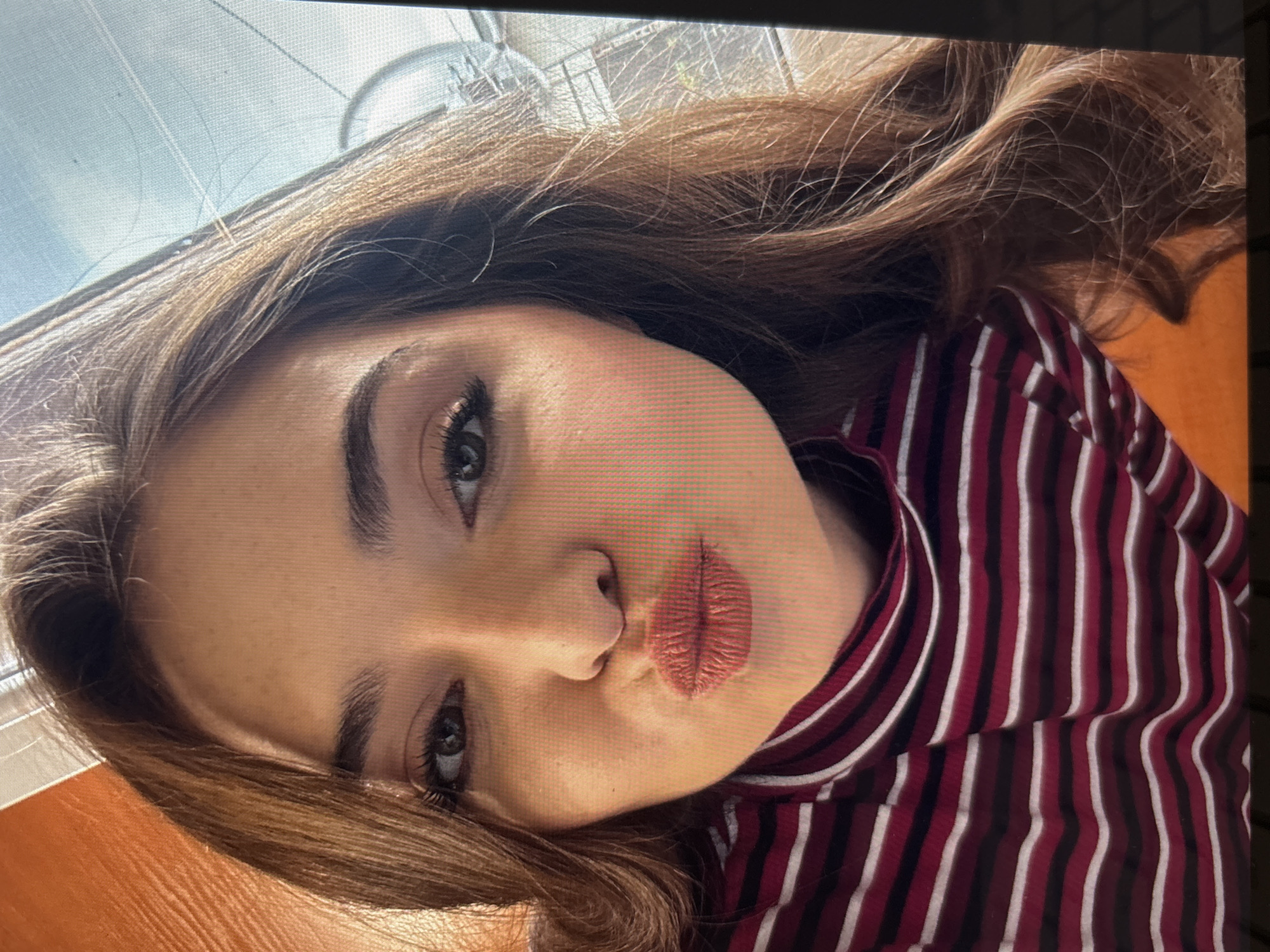 Woman takes selfie in striped turtleneck in Kostinbrod, Bulgaria