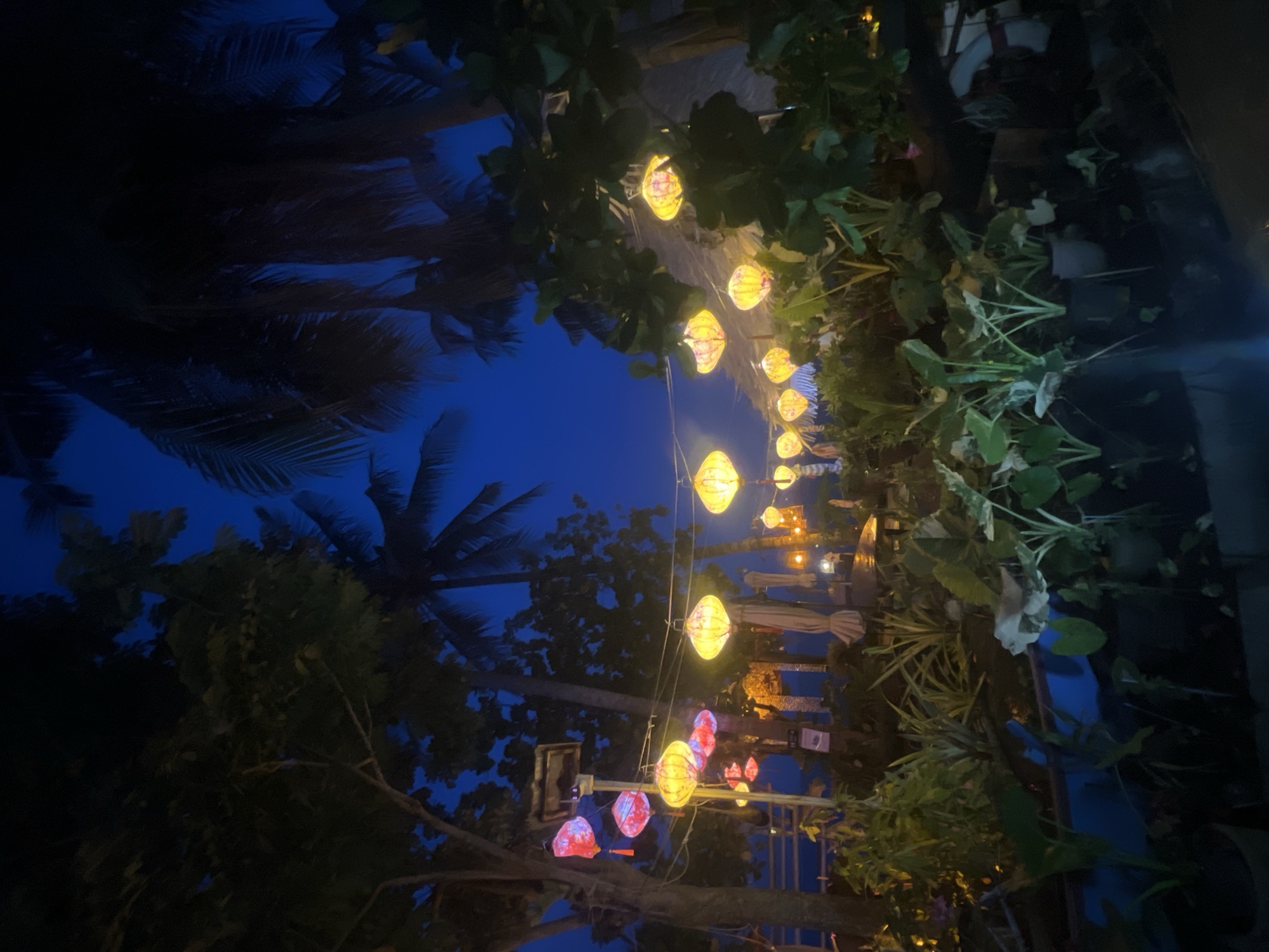 Lantern-lit beachside dining spot at dusk in Ko Samui