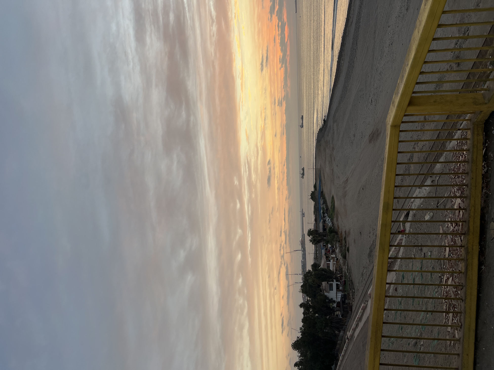 Sunset over Arica's coastline amid active high-rise construction