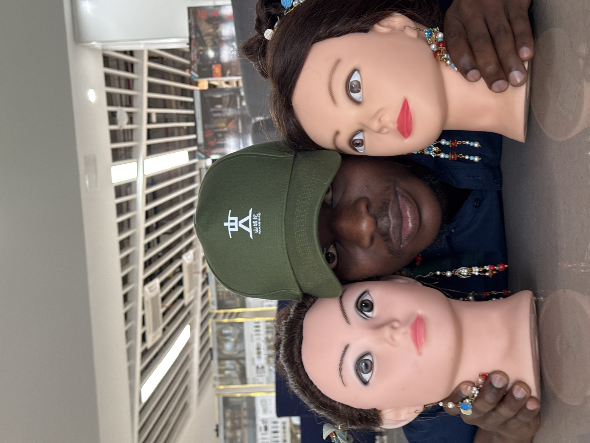 Posing with ornate mannequin heads at a Jiangjin retail space