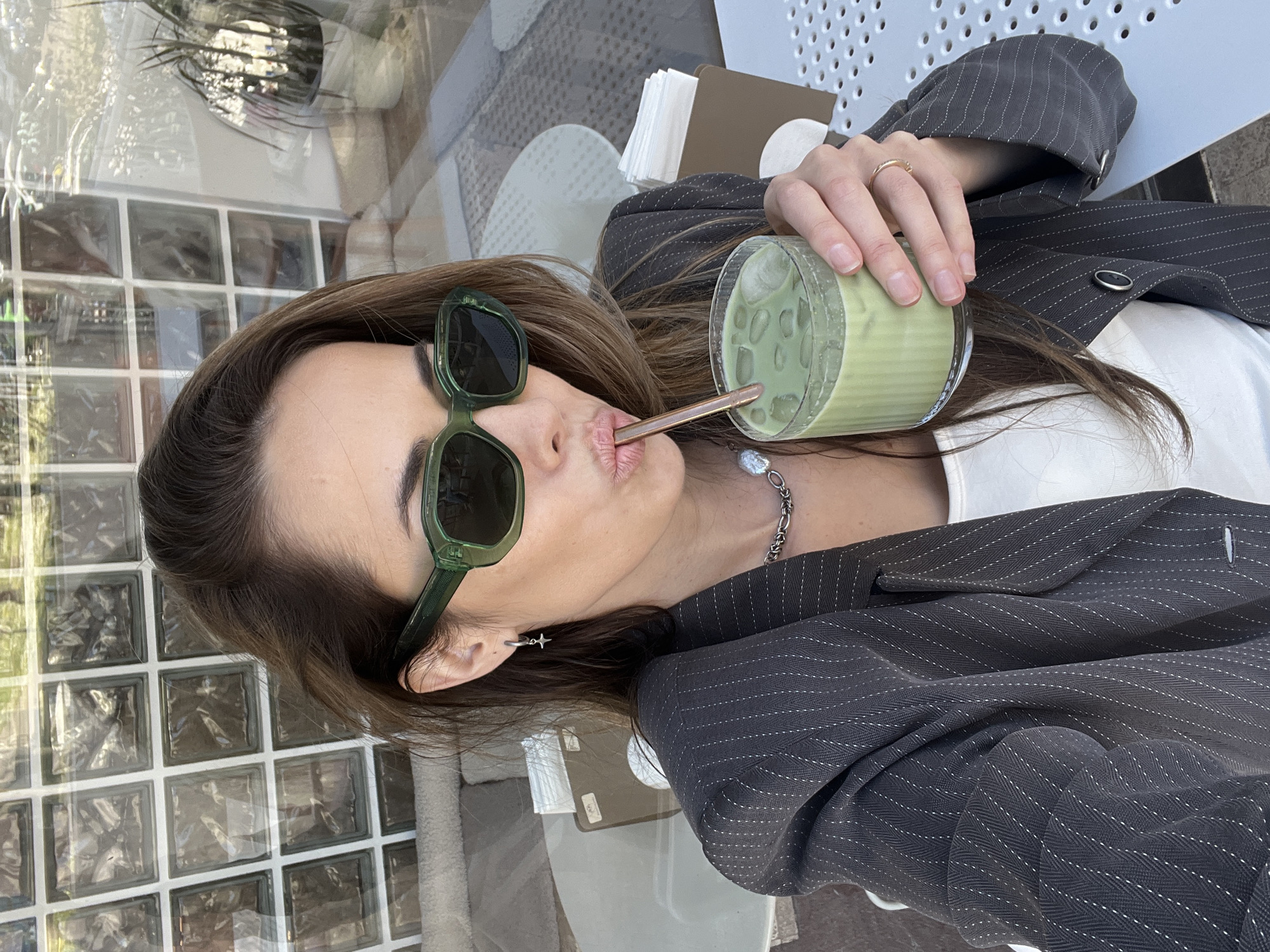 Woman enjoys matcha drinks at Montenegro cafe amid spring flowers