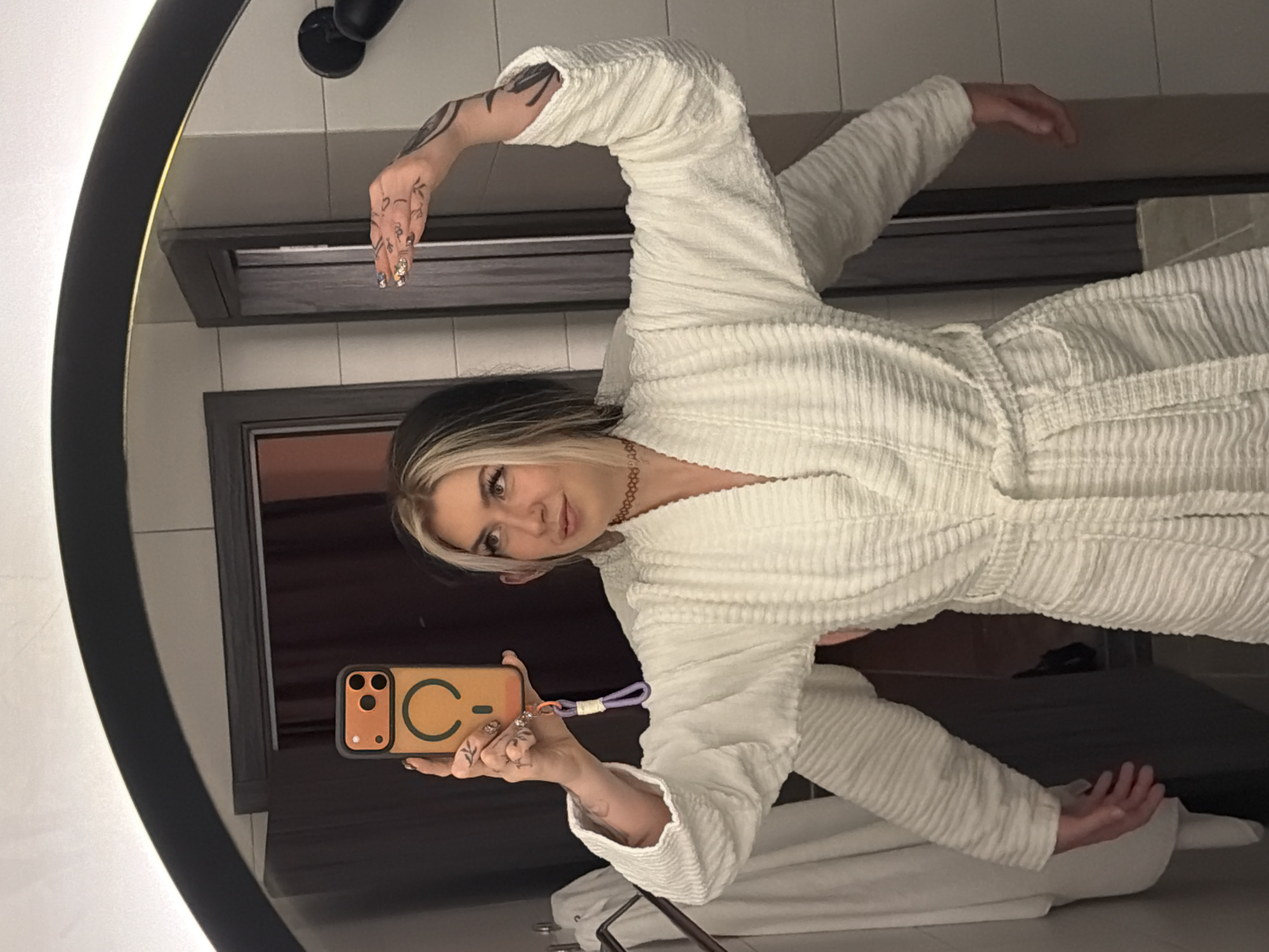 Woman takes mirror selfies in Belgrade bathroom