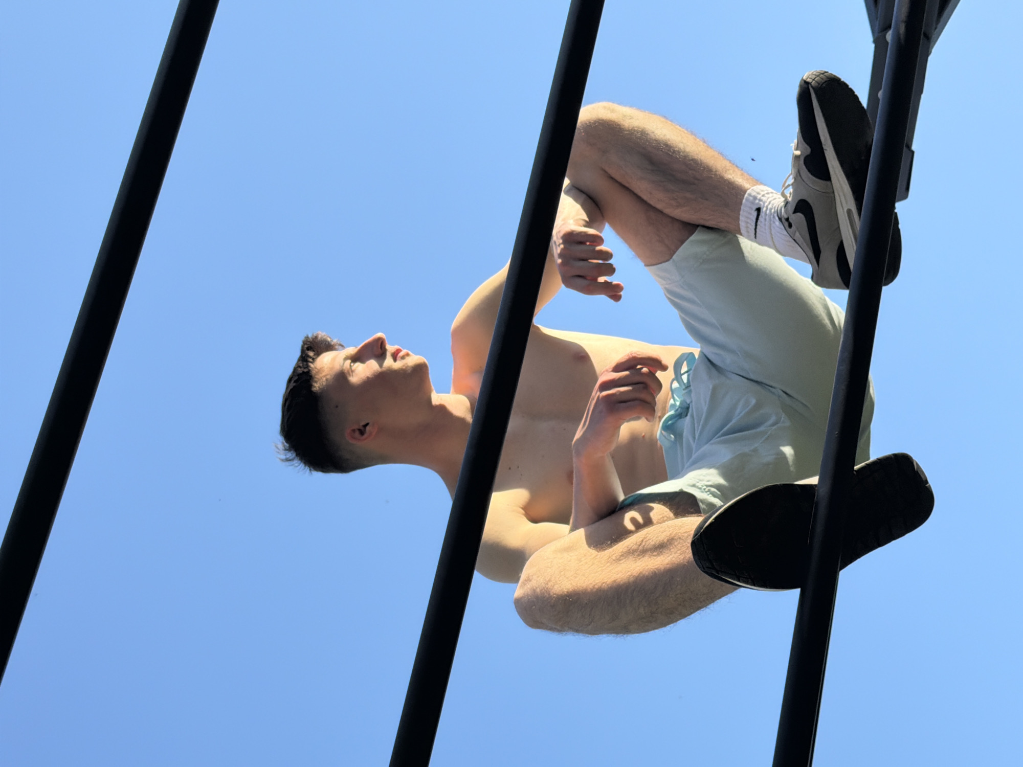 Young gymnast performs acrobatics in Burgas park during sunset