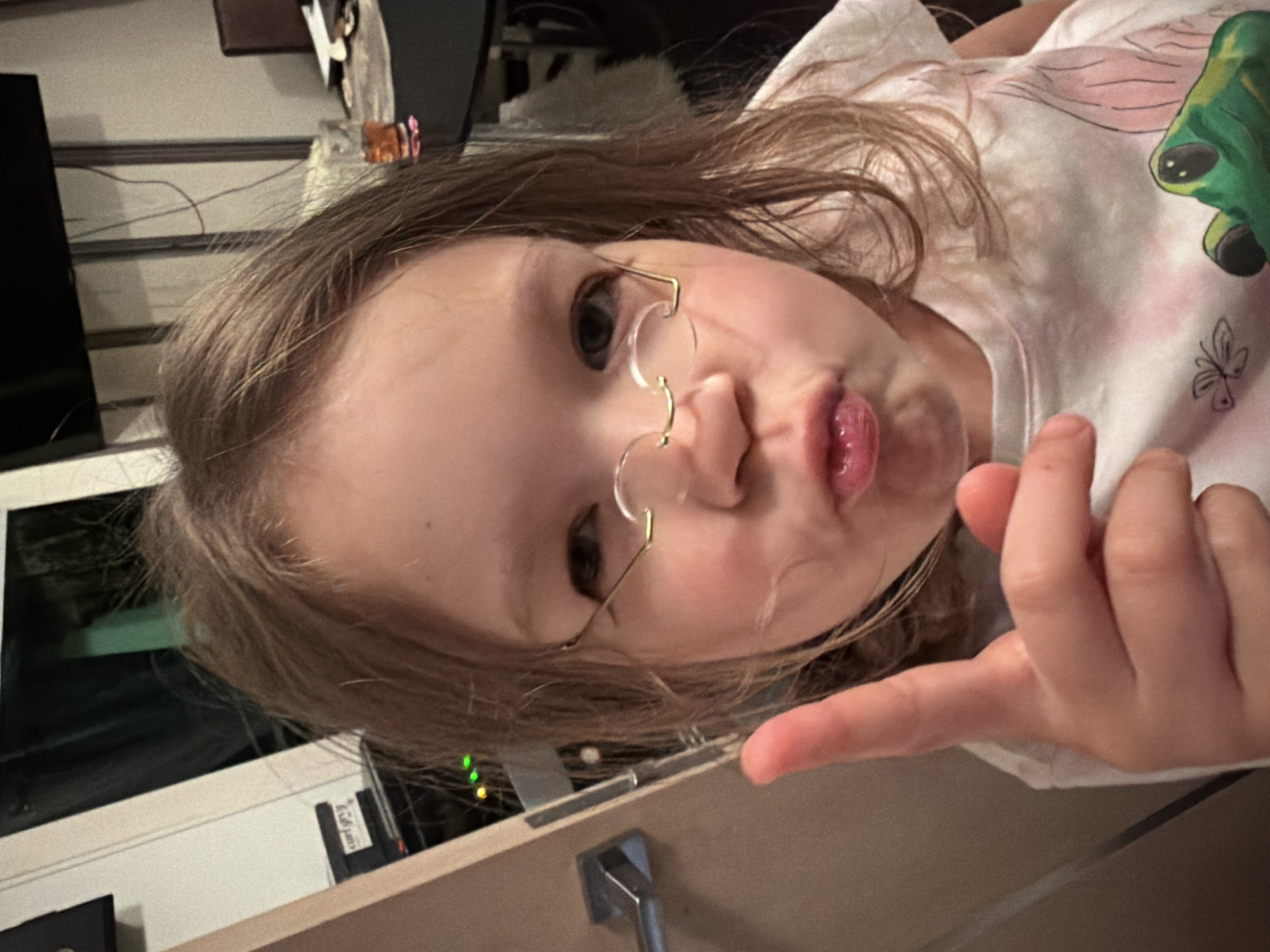 Girl makes pouting gesture while pointing in Saint Petersburg