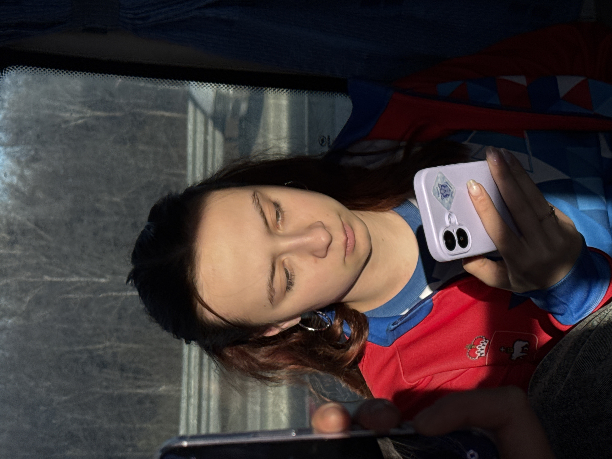 Woman uses phone while seated in vehicle in Yanychi