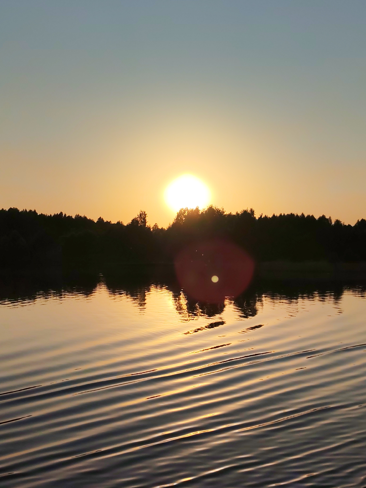 Evening boat journey documented on Russian waterway near sunset
