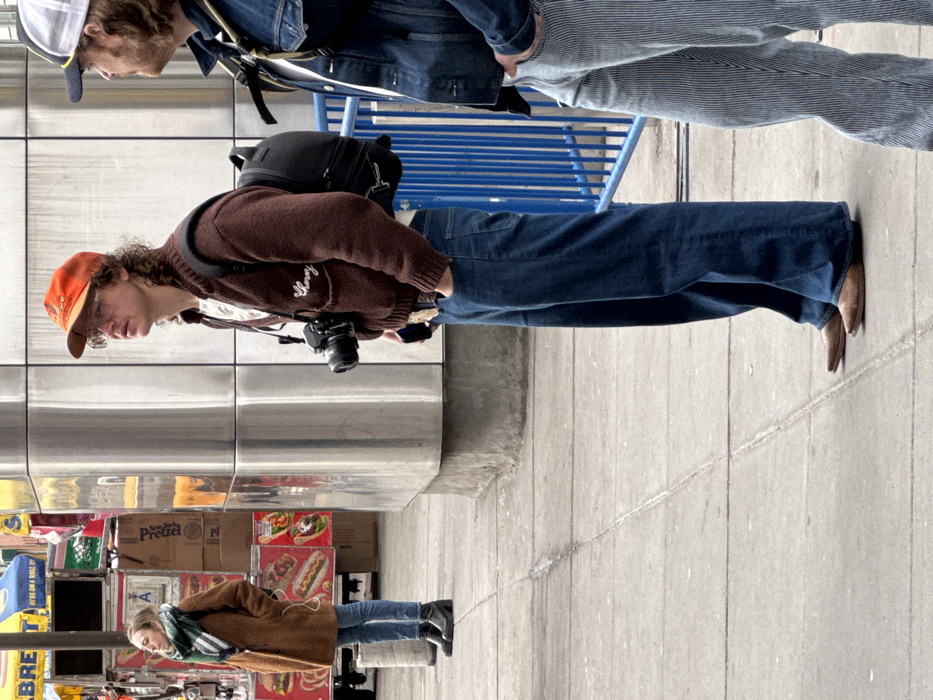 New Yorkers in winter clothes spotted outdoors, descending subway