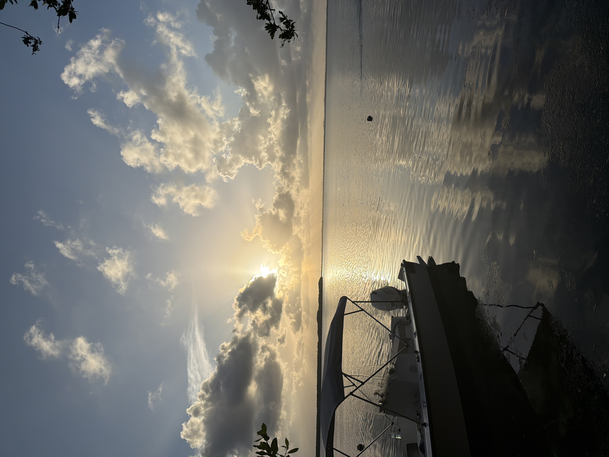 Sunset captured over Cancún waters with docked boat