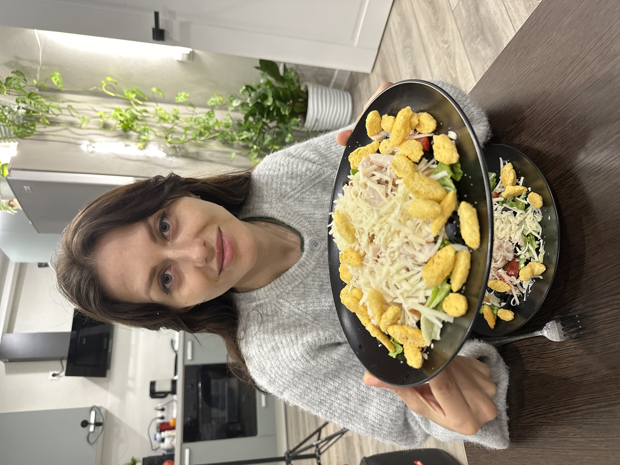 Woman prepares Caesar salads in Murino kitchen