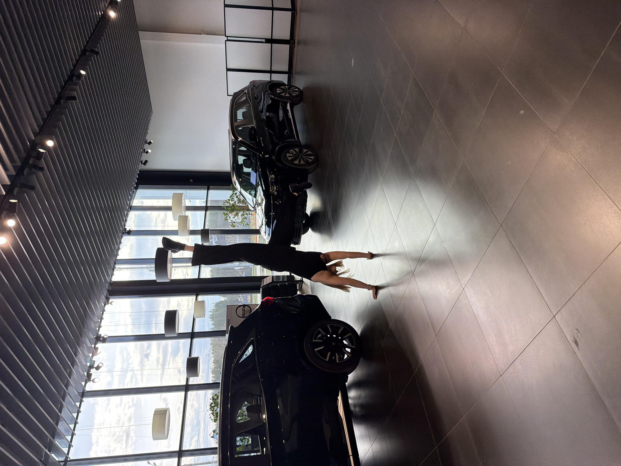Woman performs gymnastics in Russian car dealership showroom