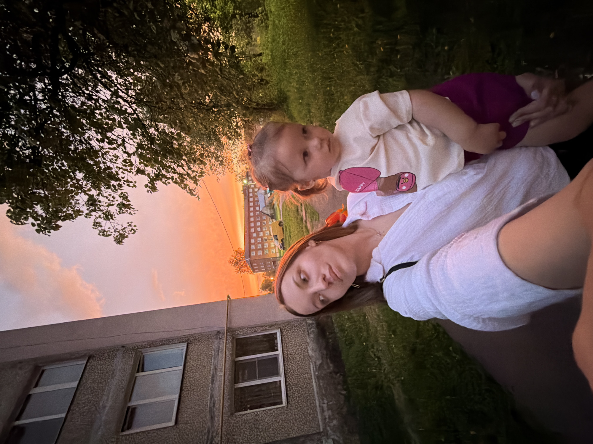Mother and child enjoy sunset selfies in Reshetnikovo neighborhood