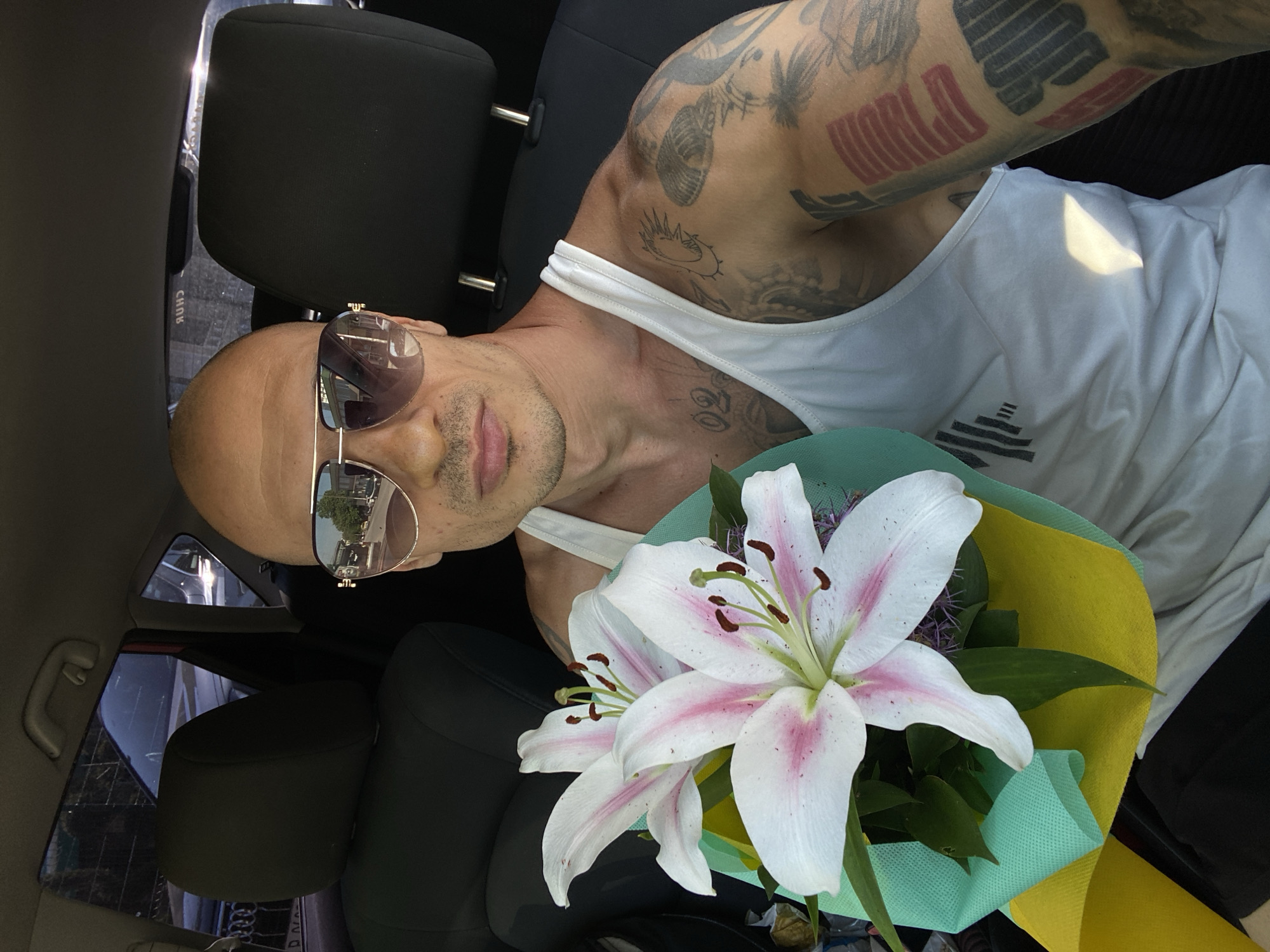 Parked in Pleven with a bouquet of lilies in hand