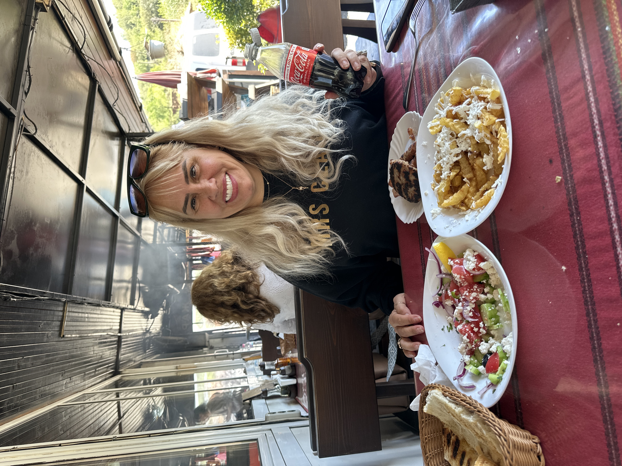 Woman enjoys traditional Bulgarian grilled meal in Kresna