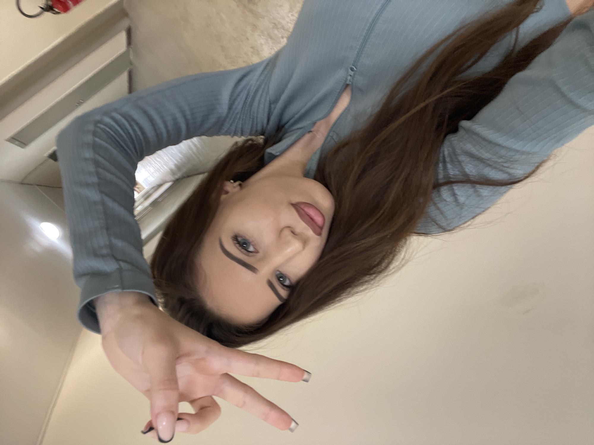 Woman takes indoor selfies in Veliko Tarnovo, Bulgaria