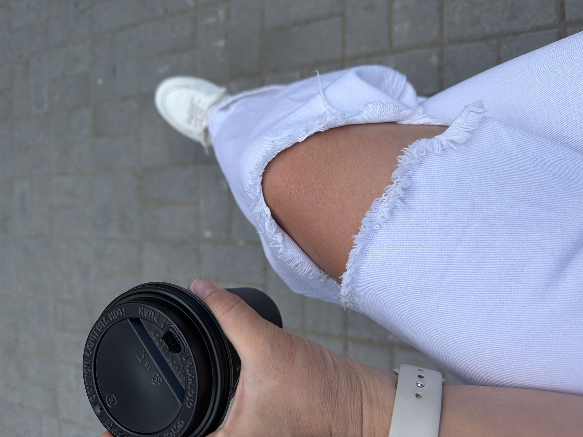 Morning coffee break captured on gray pavers in Chaikovsky