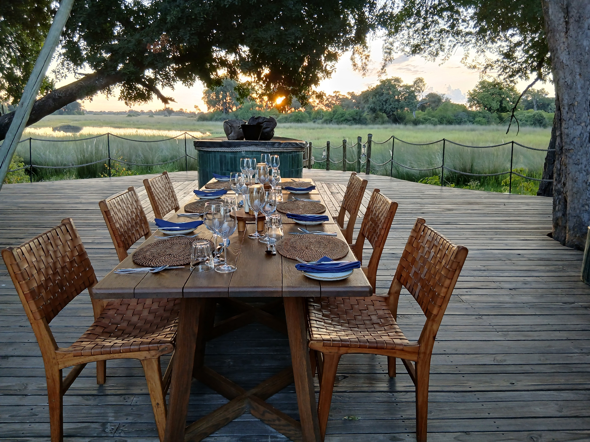Safari dining setup overlooking Botswana wetlands captured on deck