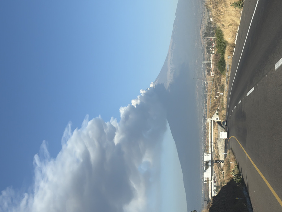 Volcano emits smoke near Mexican town, vehicles pass nearby