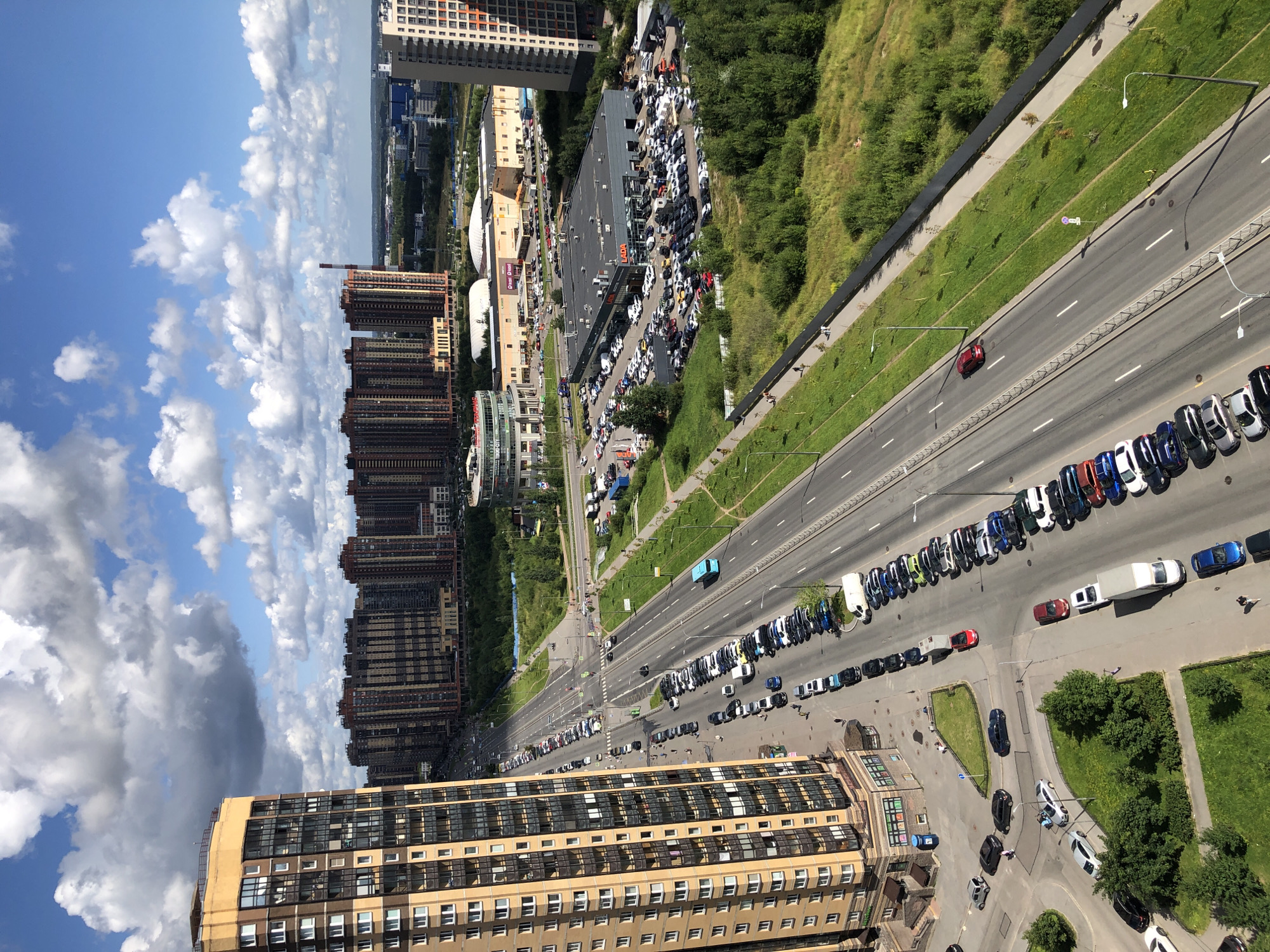Aerial sweep of a busy urban residential district on a clear morning