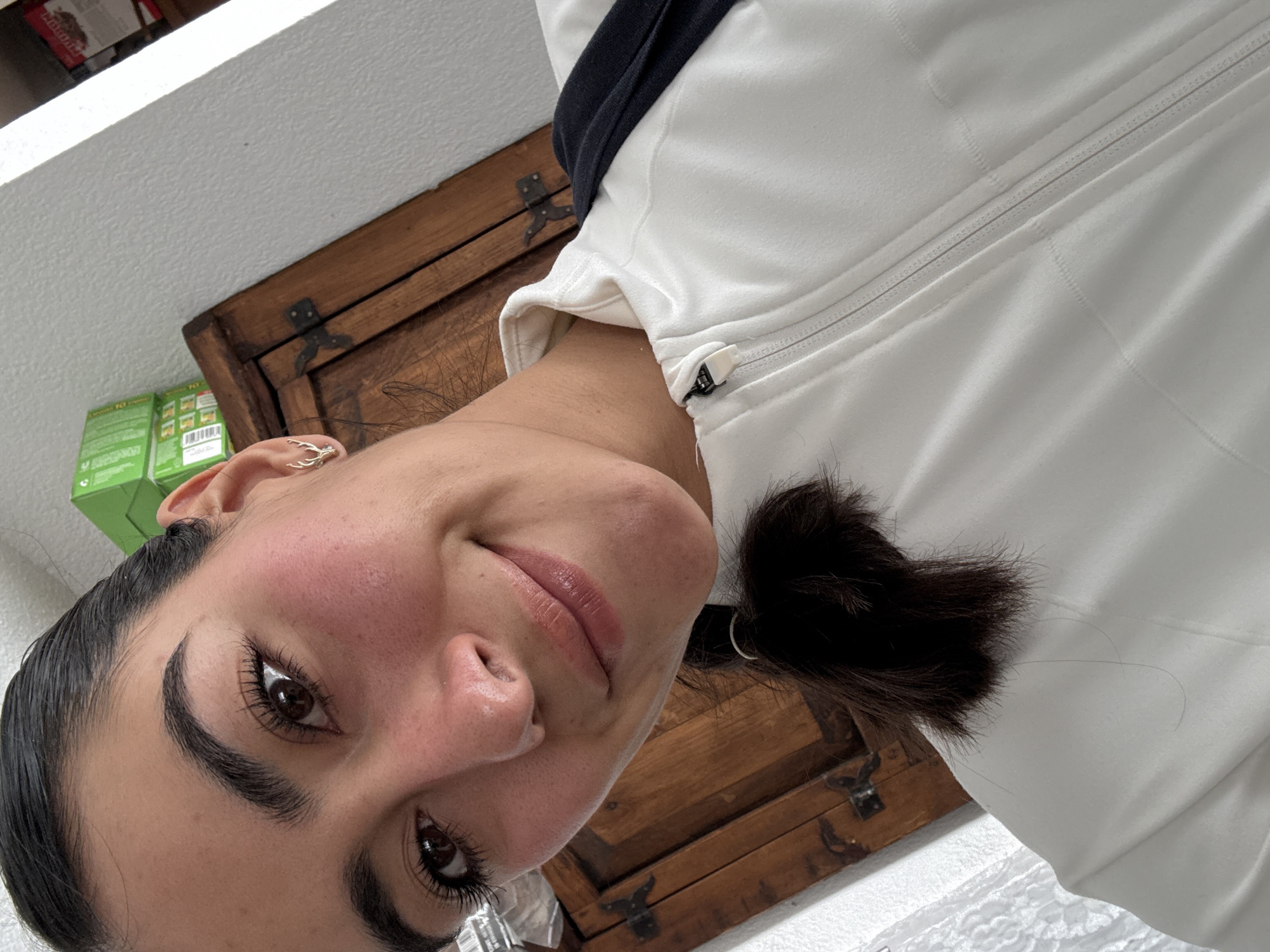 Woman takes selfie in white jacket in Puebla