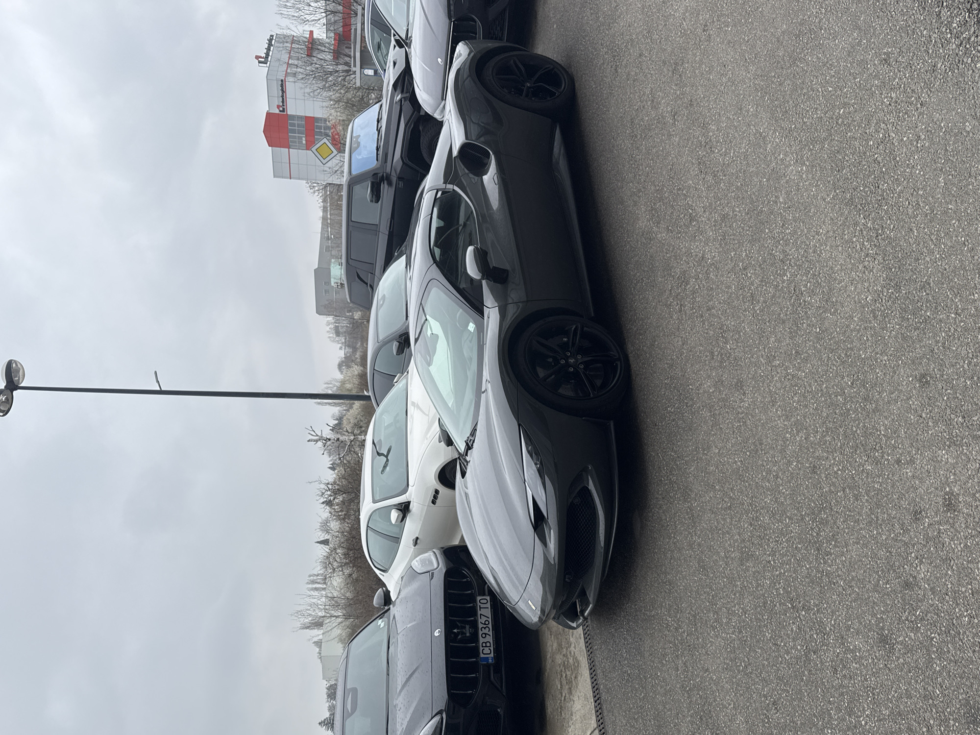 Luxury car dealership displays Ferrari and Maserati vehicles in Sofia