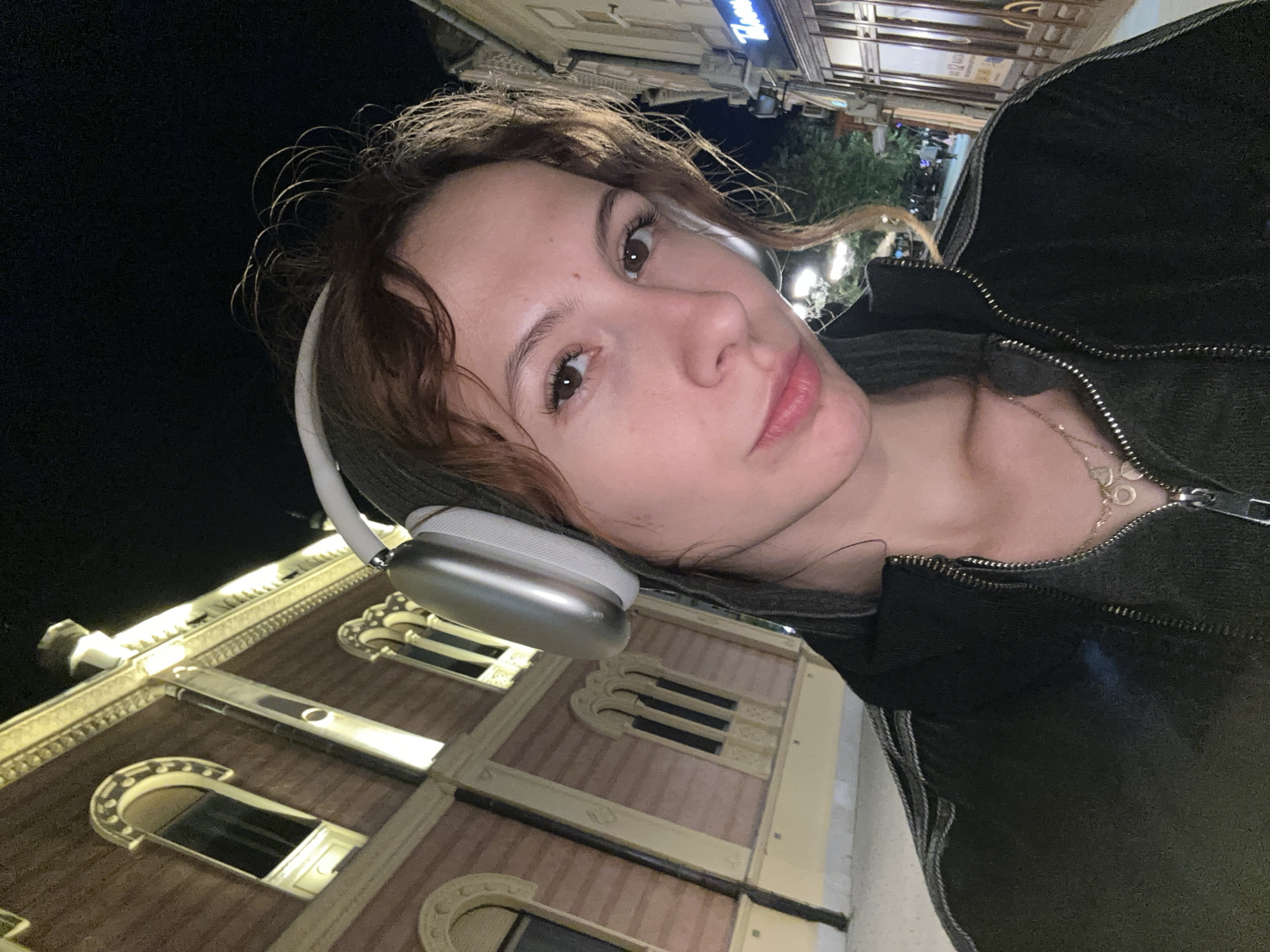 Woman takes nighttime selfies at Serbian National Theatre, Novi Sad