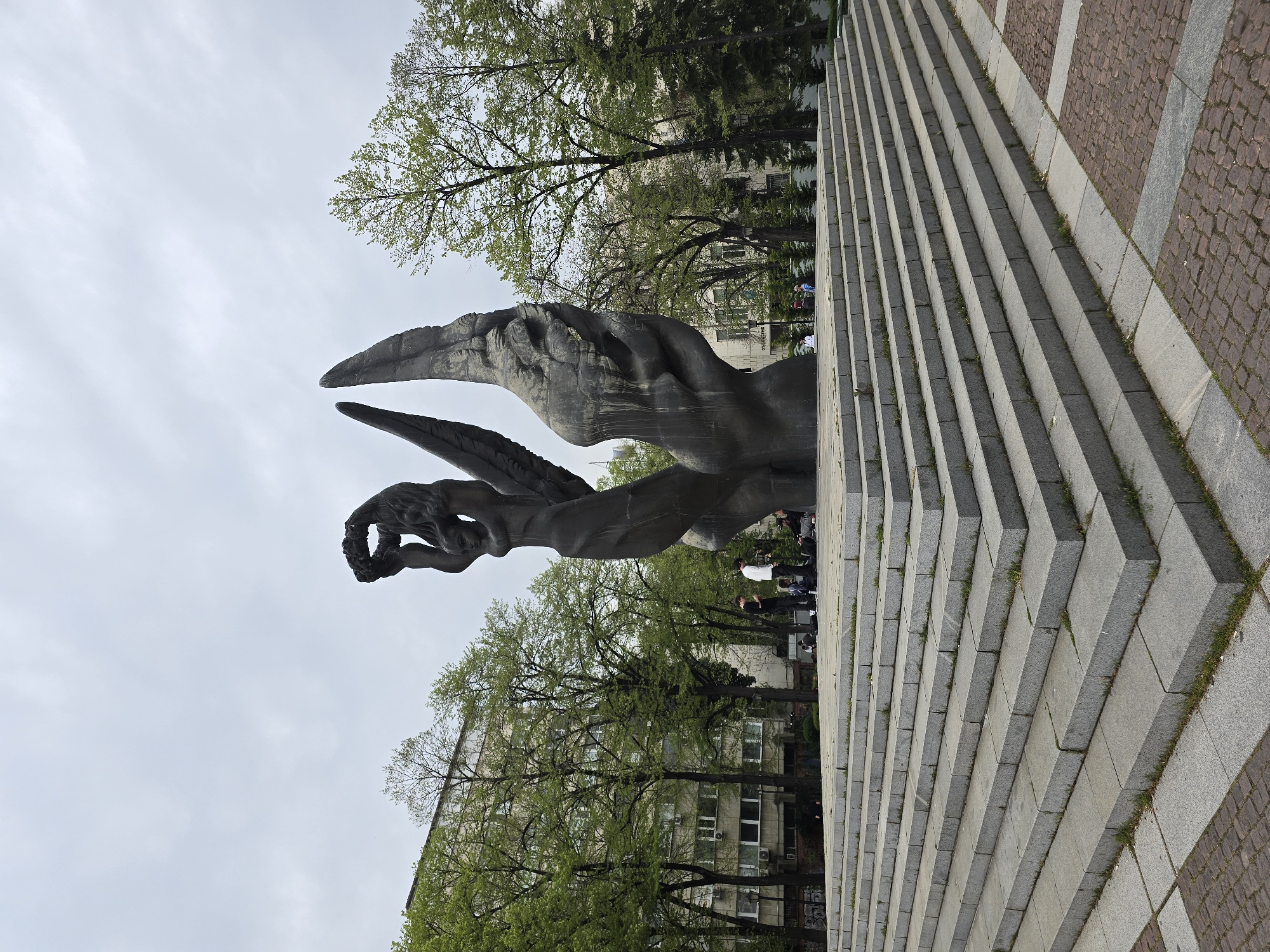Cats and flora observed around dark winged monument