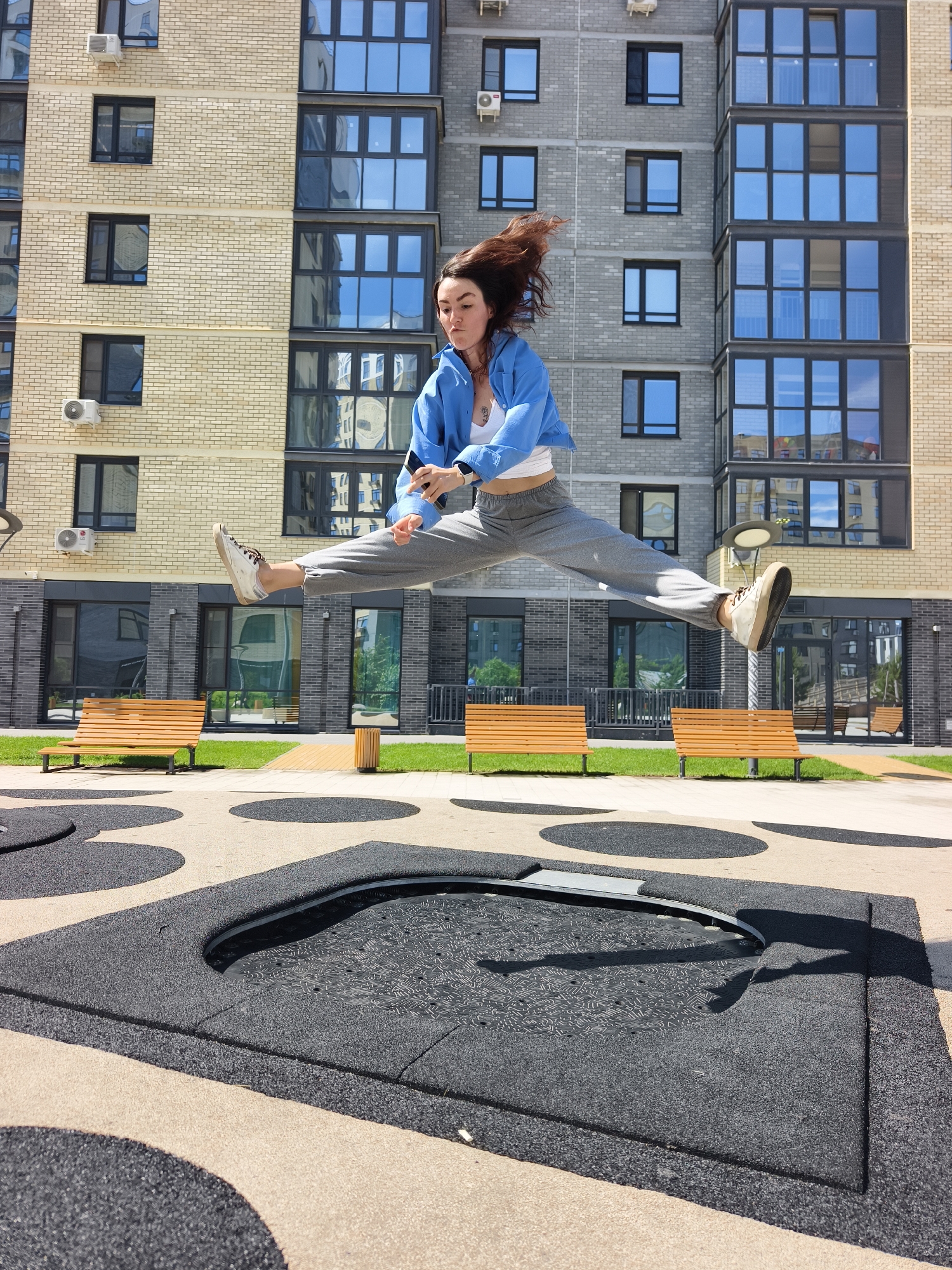 Woman performs acrobatic jumps on trampoline in Tyumen courtyard