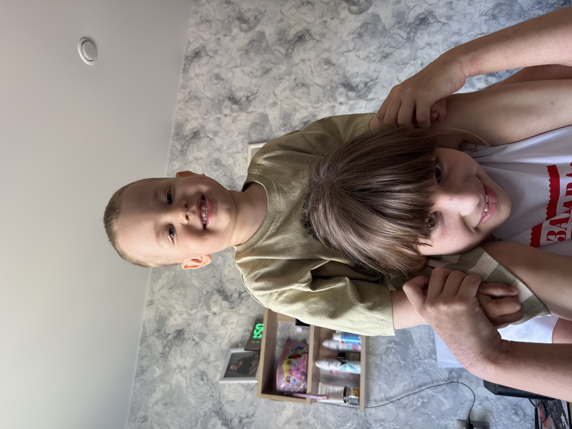 Siblings pose for indoor photo in Rusanovo, Russia