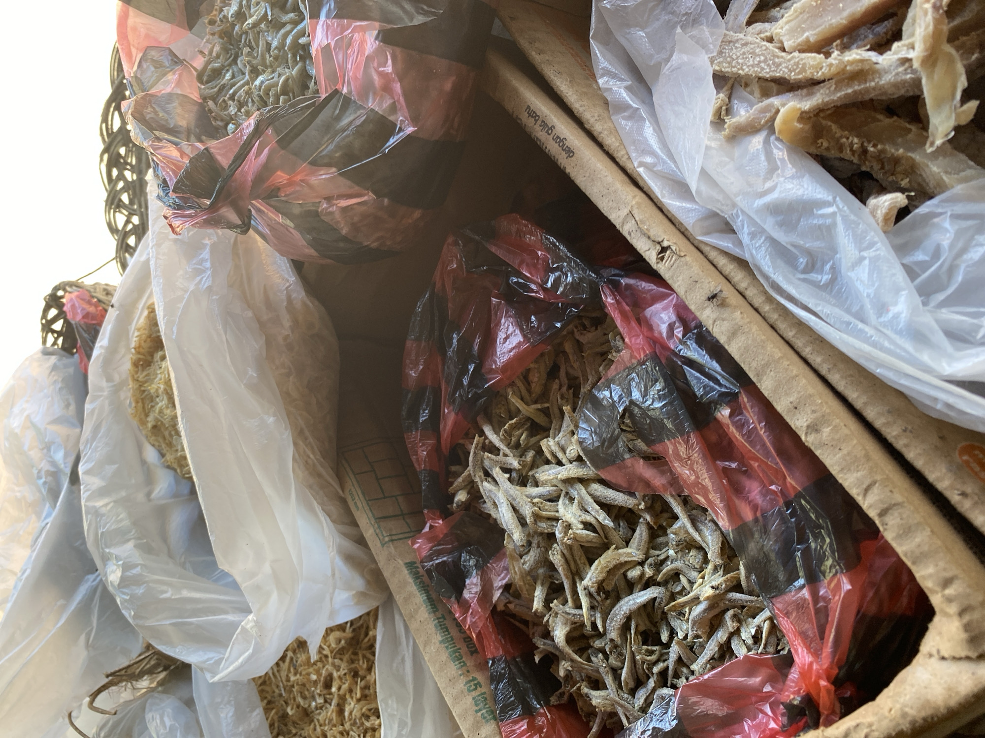 Local market stall stocked with dried goods and fresh produce