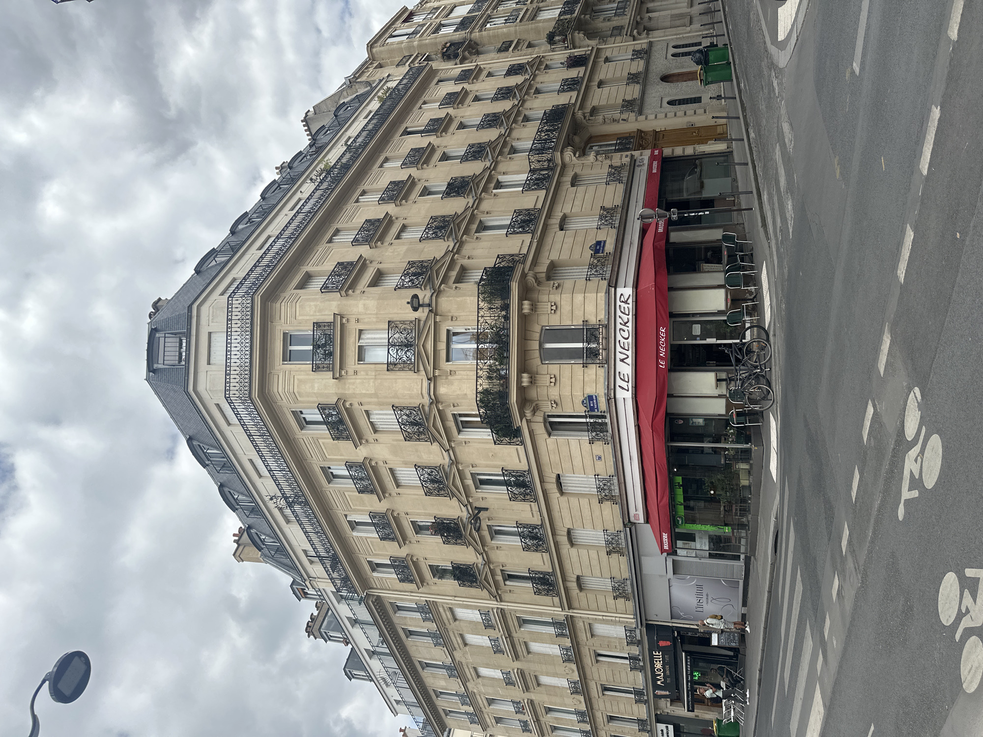 Paris streetscape: Haussmann facades, ornate stone, and a Tower glimpse