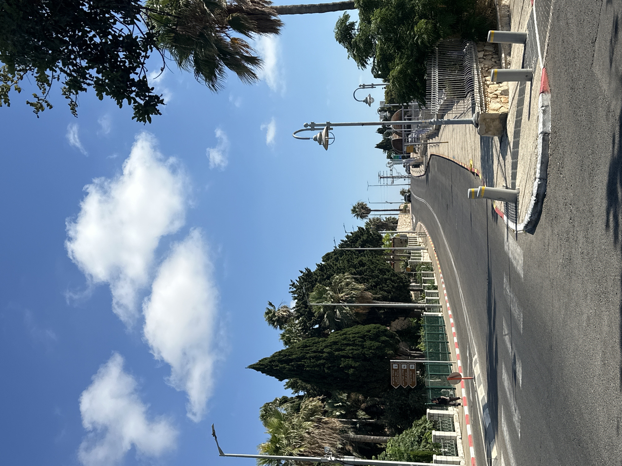 Street-level scenes from a Haifa neighborhood on a sunny afternoon