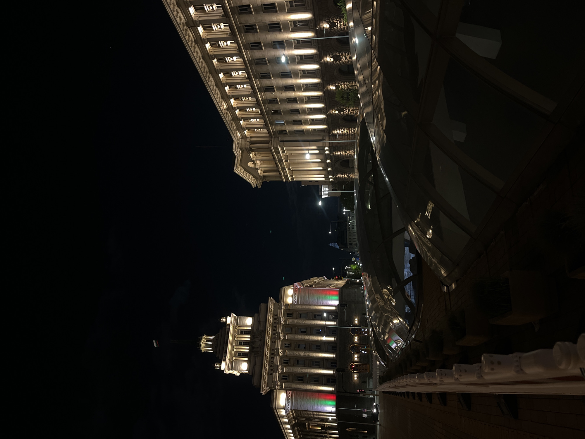 Sofia's National Assembly illuminated with Bulgarian flag colors at night