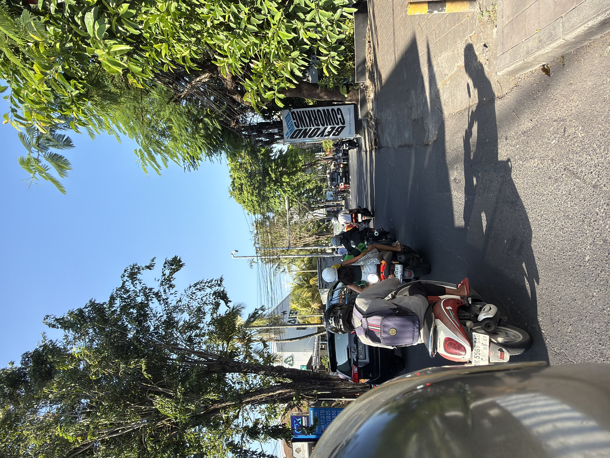 North Kuta street traffic under wires and open sky