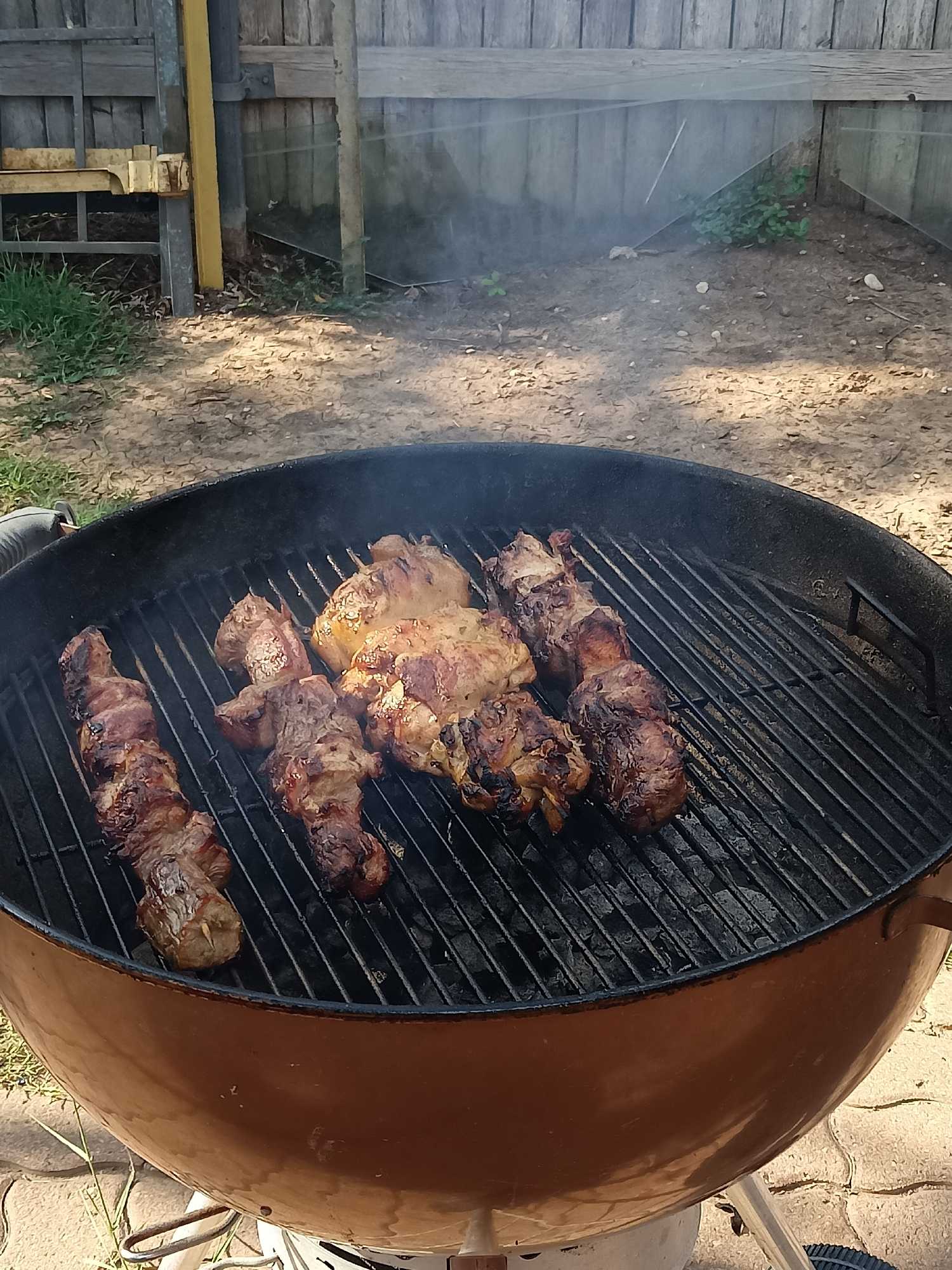 Backyard charcoal grill loaded with chicken and skewers, Amarillo