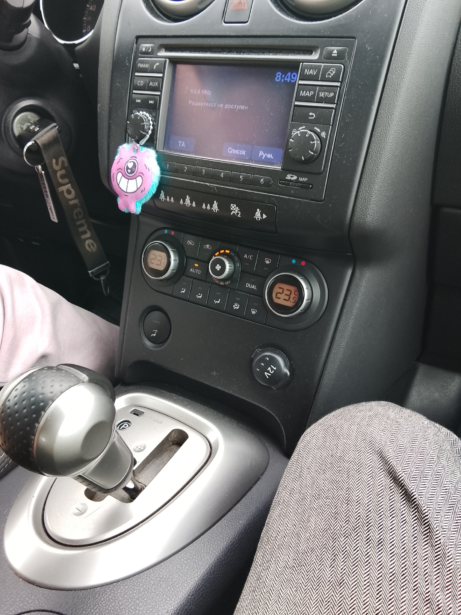 Car interior documented in Russian town shows dashboard, clothing